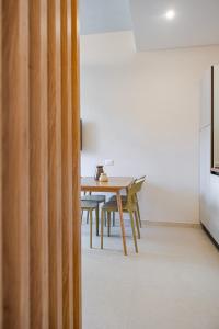 a dining room with a wooden table and chairs at Marina Suite Elba in Marina di Campo +40 photos