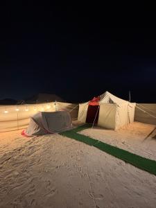 a group of tents in the desert at night at Skyrak in Umm al Qurayn
