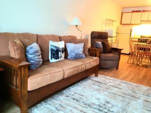 a living room with a couch with pillows on it at Magic Mountain Ski Resort in Londonderry