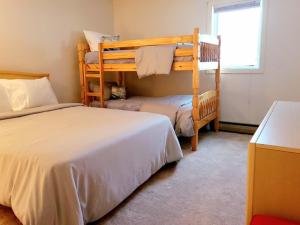 a bedroom with two bunk beds and a window at Magic Mountain Ski Resort in Londonderry +9 photos