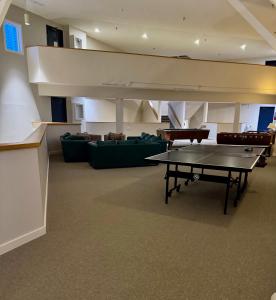 a room with a ping pong table and a couch at Magic Mountain Ski Resort in Londonderry