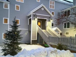 a house with a staircase in the snow at Magic Mountain Ski Resort in Londonderry