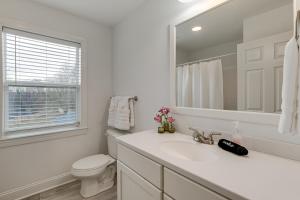 a white bathroom with a sink and a toilet at Hot Tub and Yard Temptation Stays Home in Roanoke in Cave Spring +22 photos