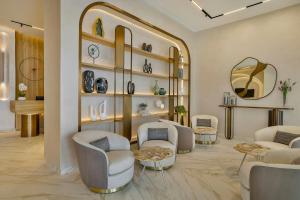 a living room with chairs and a mirror at The First Collection Waterfront, Dubai, a Tribute Portfolio Hotel in Dubai