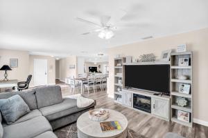 a living room with a couch and a flat screen tv at Heated Pool Family Fun at Silver Sands Clearwater in Clearwater