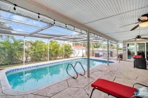 a swimming pool with a red bench next to it at Heated Pool Family Fun at Silver Sands Clearwater in Clearwater