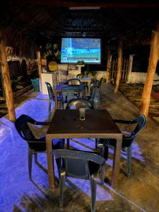 a dining room with tables and chairs and a television at Hotel Paradise in Isla Fuerte +10 photos