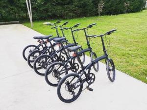 four bikes parked in a row on a sidewalk at TinyHouses & Garden in Geceľ