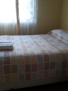 Ένα ή περισσότερα κρεβάτια σε δωμάτιο στο Cabaña familiar