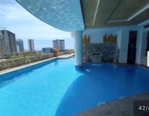 a large blue swimming pool with a view of the city at SantaMartaTerrace in Santa Marta