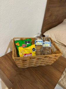 a basket with drinks and water bottles on a table at NEW! Loft in Cancun Center 5 mins from the ADO in Cancún