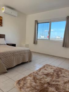 a bedroom with a bed and a large window at NEW! Loft in Cancun Center 5 mins from the ADO in Cancún