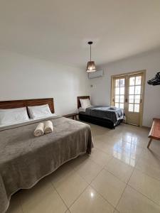 a bedroom with two beds and a pendant light at Villa das Araras Residence in Porto Seguro +137 photos