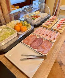 a buffet with different types of food on a table at Sport hotel POMI in Harrachov +39 photos