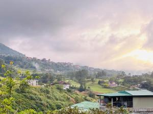 a view of a valley with houses and a hill at WN Hilltop B&B by Smart Stay 2600 in Baguio