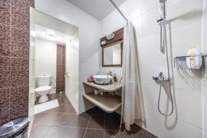 a white bathroom with a sink and a toilet at Old Town Luxury 2 Bedroom Suite 65 m2 on 3rd floor in Tallinn +14 photos