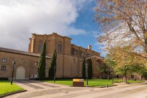 a large brick building with trees in front of it at Apartamentos La Florida in Casalarreina