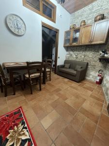 a living room with a couch and a table at Appartamento Barone in Gubbio