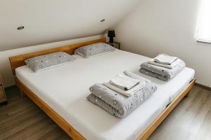 a bed with two pillows on top of it at Deluxe Apartment Seeblick in Friedrichshafen