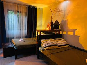 a bedroom with two beds and a window at WN Hilltop B&B by Smart Stay 2600 in Baguio
