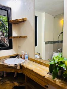a bathroom with a sink and a mirror at WN Hilltop B&B by Smart Stay 2600 in Baguio +65 photos