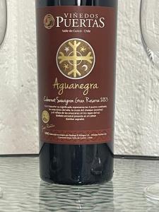 a bottle of wine sitting on top of a table at Habitación doble love con baño privado in Curicó