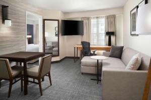 a living room with a couch and a table at Residence Inn by Marriott New Orleans Metairie in Metairie