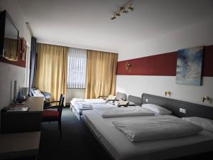 Ένα ή περισσότερα κρεβάτια σε δωμάτιο στο Hotel Merian