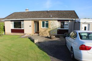 a white car parked in front of a house at Premier Room in Kelso