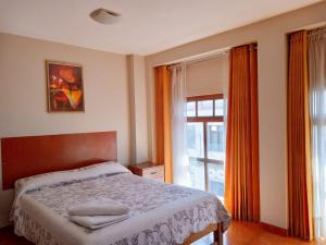 a bedroom with a bed and a large window at Casa de Isabel in Arequipa +91 photos