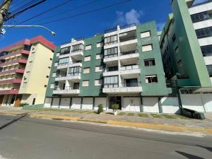 an apartment building on the side of a street at Apartamento na praia in Capão da Canoa