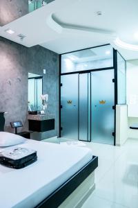 een slaapkamer met een groot bed en een spiegel bij Prime Motel Piracicaba in Piracicaba