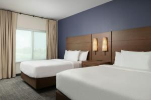 a hotel room with two beds and a window at Residence Inn Pearland in Pearland +26 photos