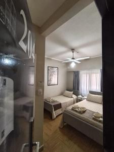 a living room with two beds and a couch at Hotel Jorgito in Mar del Plata