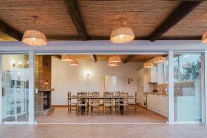 een open keuken en eetkamer met kroonluchters bij Monte Gerações - Complete House - Heated pool - Typical Algarvian - close to Quinta Lago Vale Lobo and Vilamoura in Almancil