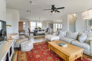 a living room with a couch and a table at Scenic Sandia Mtn Views! Cozy Rio Rancho Retreat in Paradise Hills