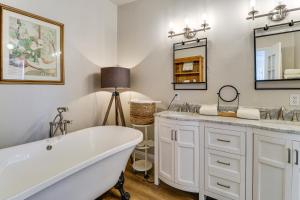 a bathroom with a tub and a sink and a mirror at Scenic Sandia Mtn Views! Cozy Rio Rancho Retreat in Paradise Hills +20 photos