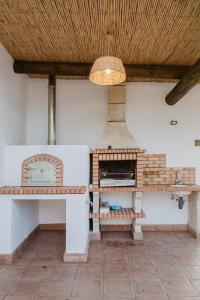 een keuken met een fornuis en een bank in een kamer bij Monte Gerações - Complete House - Heated pool - Typical Algarvian - close to Quinta Lago Vale Lobo and Vilamoura in Almancil