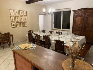 a dining room with a long table and chairs at La Hulottière in Saint-Rémy-du-Plein