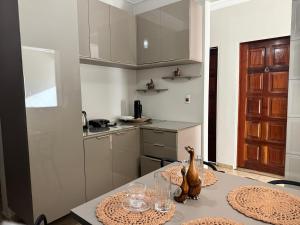 a kitchen with a table with plates and glasses on it at Centro Brasil Apartamento in Santarém +14 photos