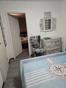 a bedroom with a bed with a blue blanket on it at Heimathafen Ückeritz Boutique Hotel in Ueckeritz