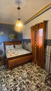 a bedroom with a bed and a chandelier at Skyatlantic guesthoüse in Douala +11 photos