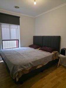 a bedroom with a large bed in a room at Westcott in Rockbank
