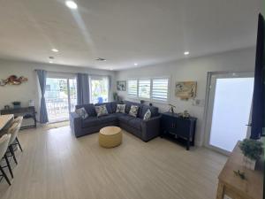 a living room with a couch and a white screen at Direct access Canal front with Pool 2 bed 2 bath in Marathon