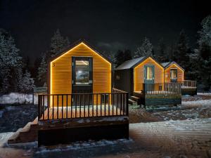 twounits of a cabin in the snow at night at Arctic circle cabin 3 in Rovaniemi