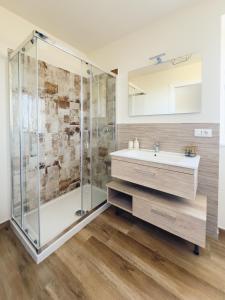 a bathroom with a shower and a sink at Il Grande Cipresso B&B in Castelnuovo