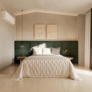 a bedroom with a large white bed with green cabinets at Zante Pantheon Hotel in Tsilivi