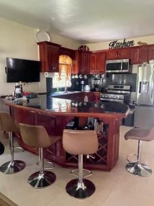a kitchen with a large kitchen island with bar stools at A taste of M&M in Belize City