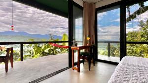 a bedroom with a bed and a view of the ocean at Searenity Octopus Cottage in Port Antonio