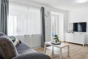 a living room with a couch and a table at Casa 1920 Apartment in Bovec +14 photos